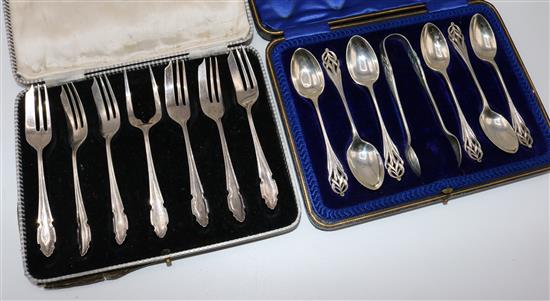 Set of silver cake forks and another set of silver teaspoons and tongs (both cased)